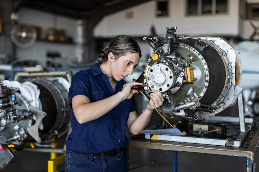 A technician working on a mechanical component