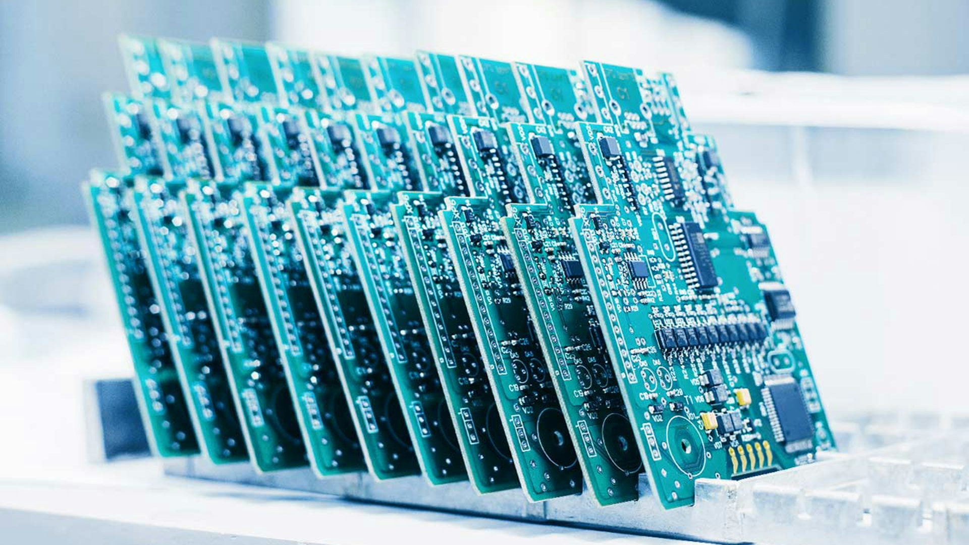 Several printed circuit boards (PCBs) displayed in a rack.