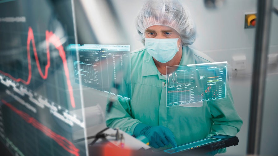Engineer looking at a digitized computer screen while holding a tablet