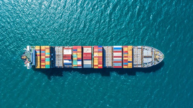 An aerial view of a cargo ship in the ocean.