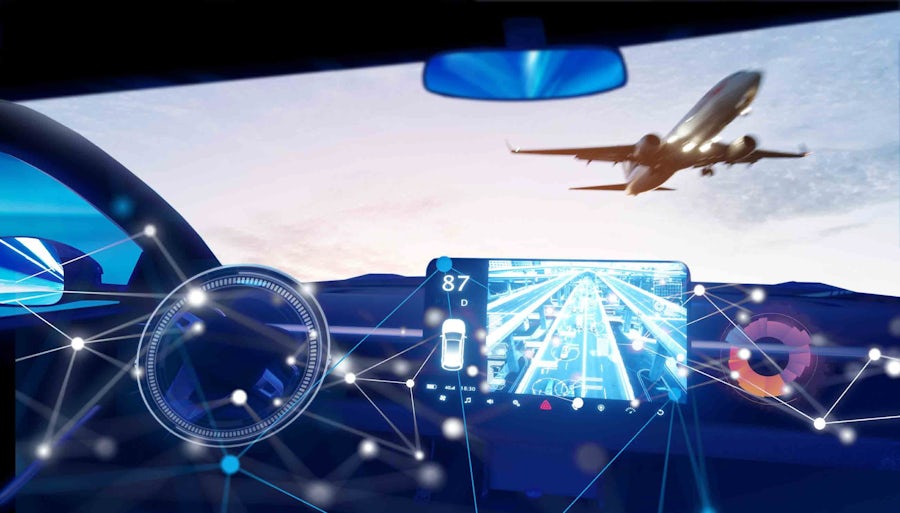 Airplane flying over a car with an on-board monitor that's tracking the car's driving speed, GPS and other key information.