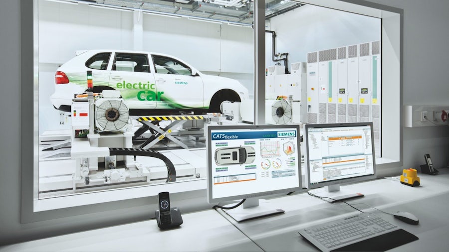 An electric vehicle shown with computer screens in the foreground displaying systems engineering software to depict the benefits of aligning automotive software and hardware