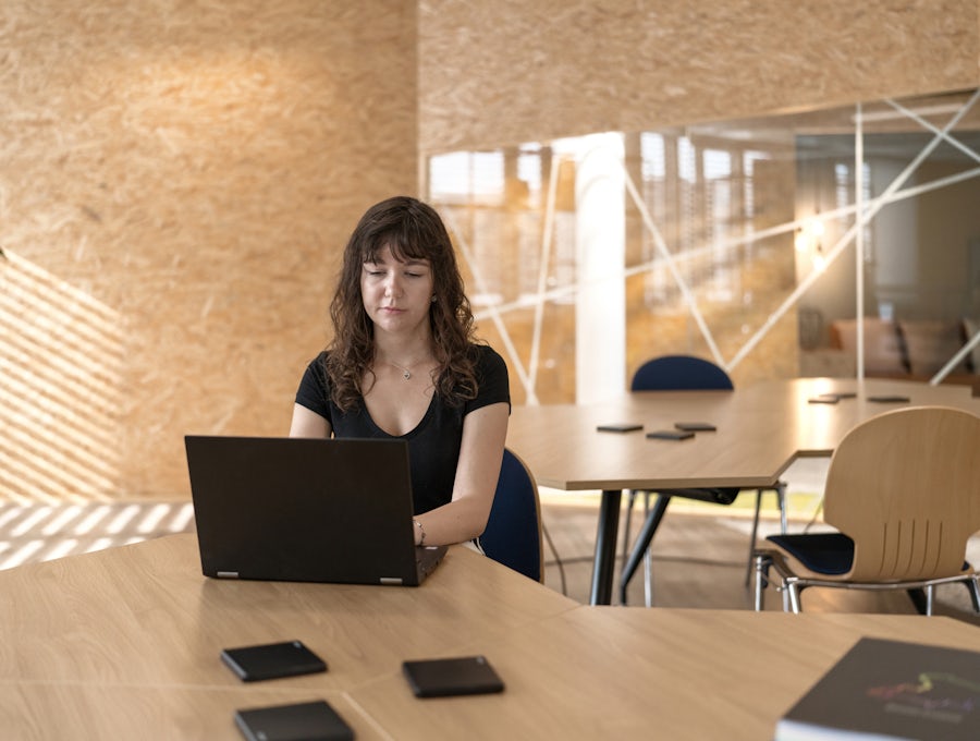 Women sitting in an office space working on her computer