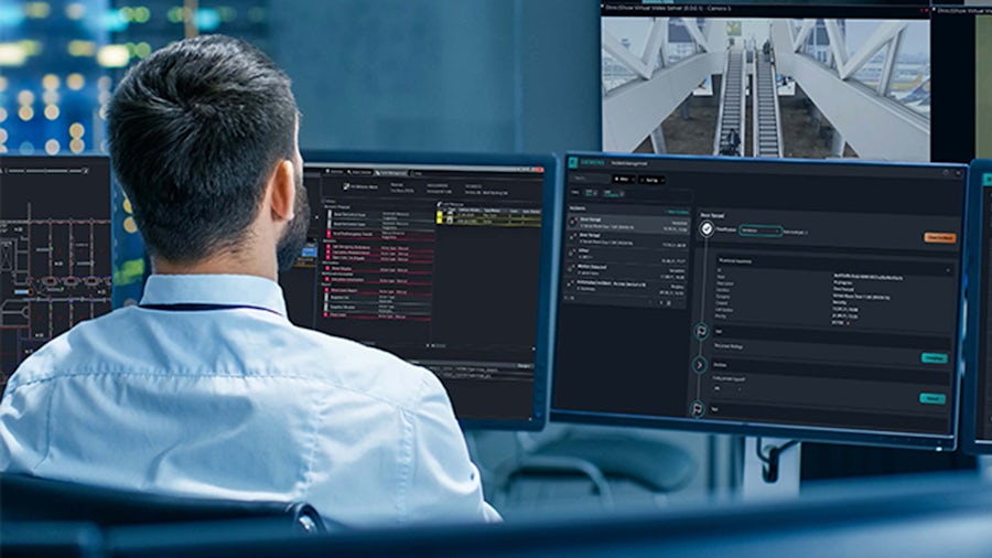 Security specialist reviews system data on whitepaper cover page.