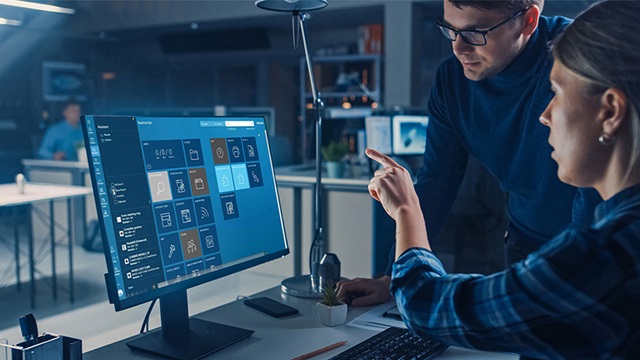 Two people working on a computer.