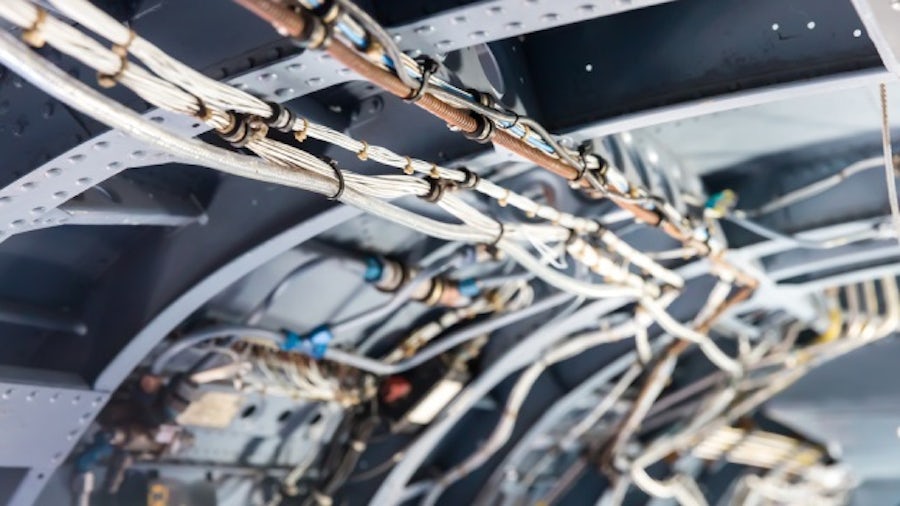 Inside an airframe fuselage showing a section of the aircraft wire harness design