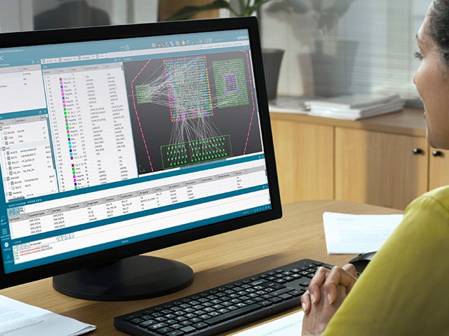 Woman at a computer using IC Packaging's new software update with a modern GUI and UX. 