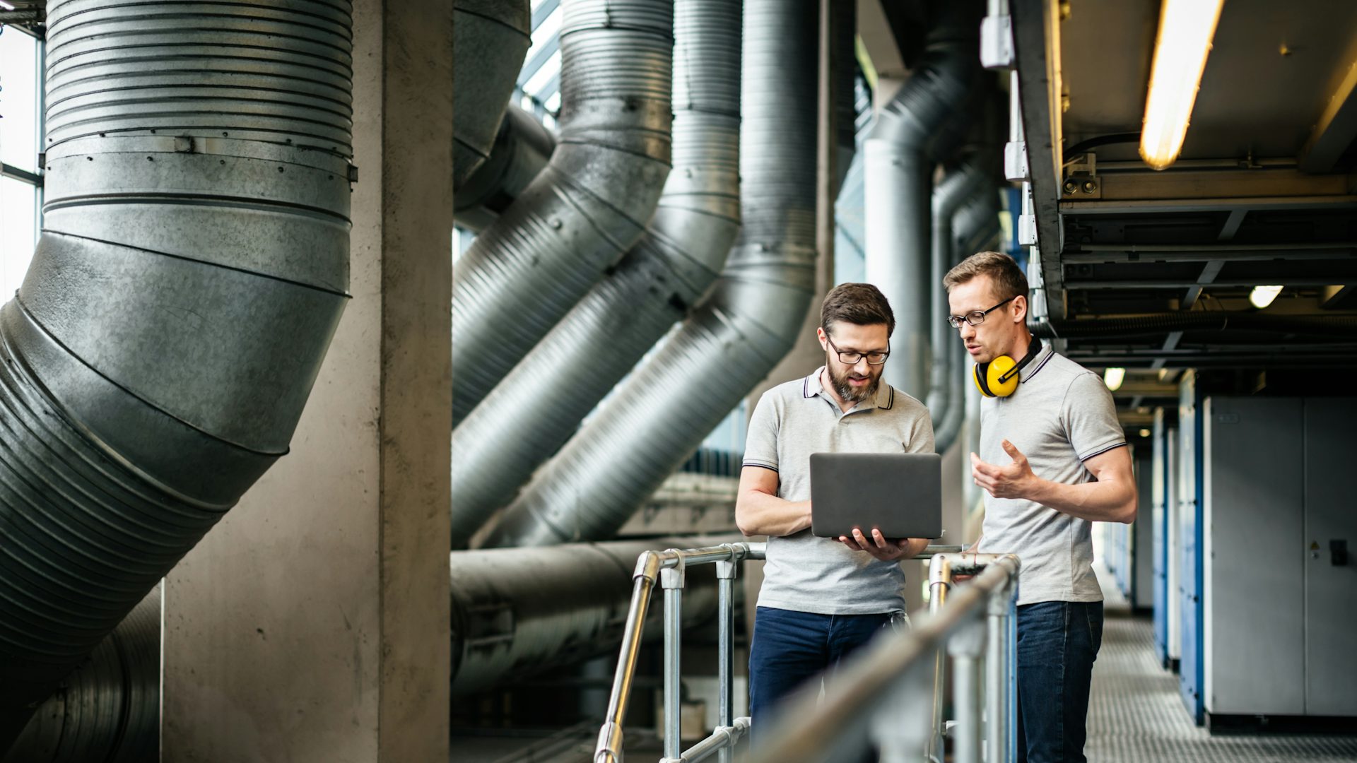 Two men working together on a computer.