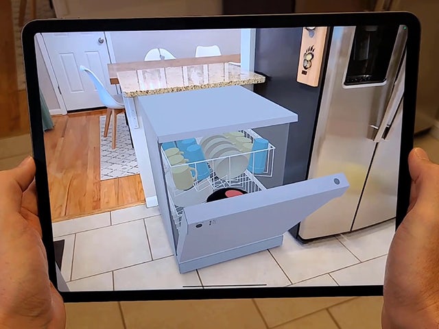 Augmented Reality in Teamcenter Share shown on a tablet with a dishwasher depicted in AR