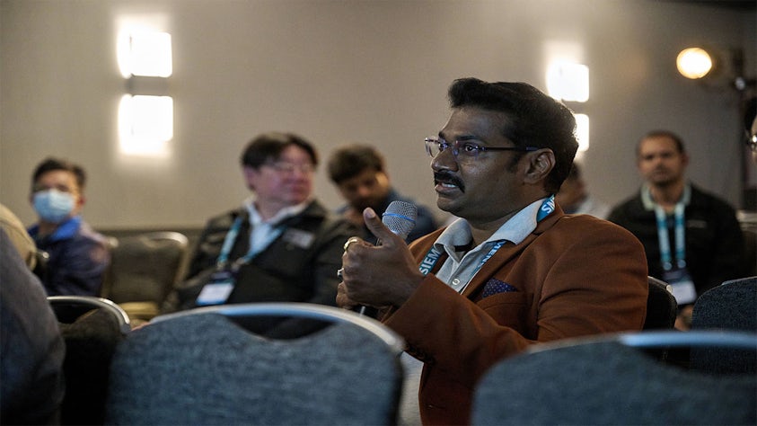 A member of the Siemens User2User conference asks a question during a session.