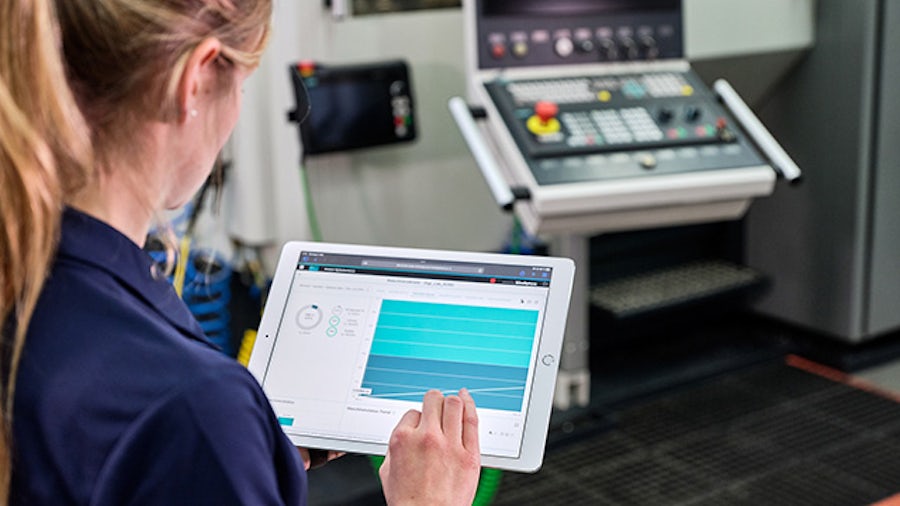 Žena používající tablet ve výrobním prostředí CNC