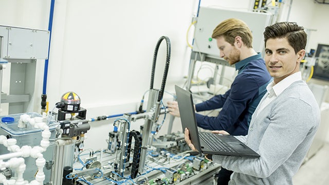 Electronics manufacturing execution system employees working tool in a lab environment. 