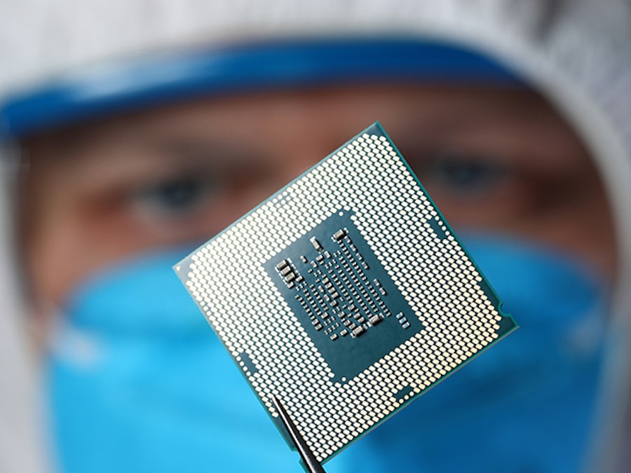 Researcher holds integrated circuit chip