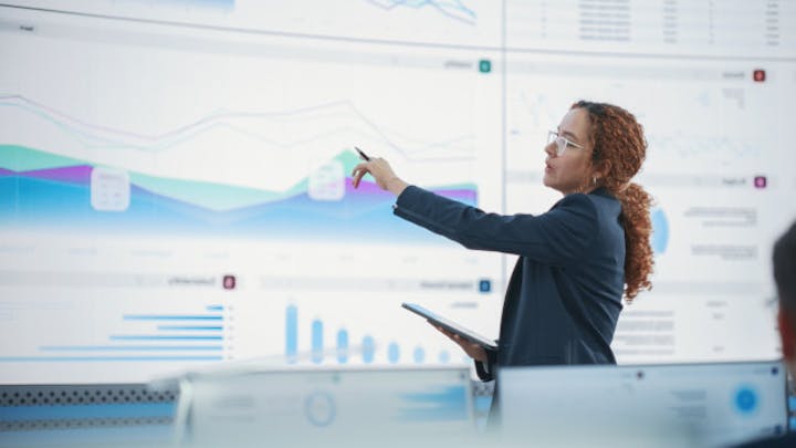 Women presenting graphs and tables.