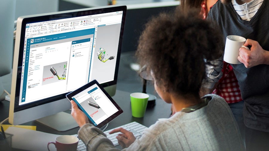 A female engineer looks at a part on a tablet while using Siemens Teamcenter Quality software to assist her in her work.