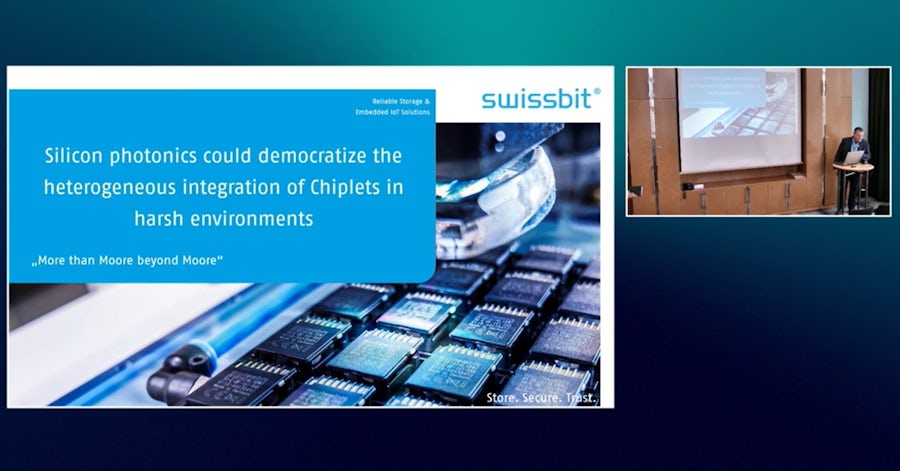 Swissbit slide shows microchips in production line with title about silicon photonics democratizing chiplet integration in harsh environments. Includes "More than Moore beyond Moore" tagline and presenter inset.