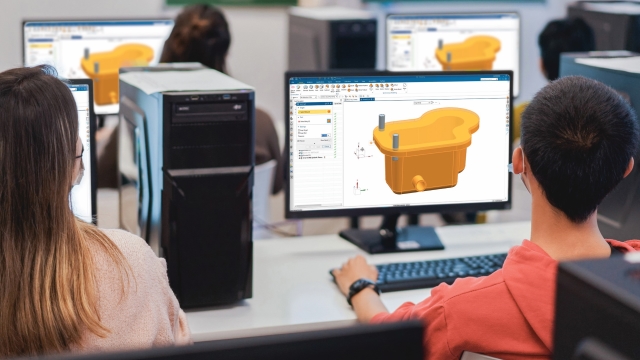 Engineering students in a classroom following along a classroom instruction of Designcenter NX CAD software