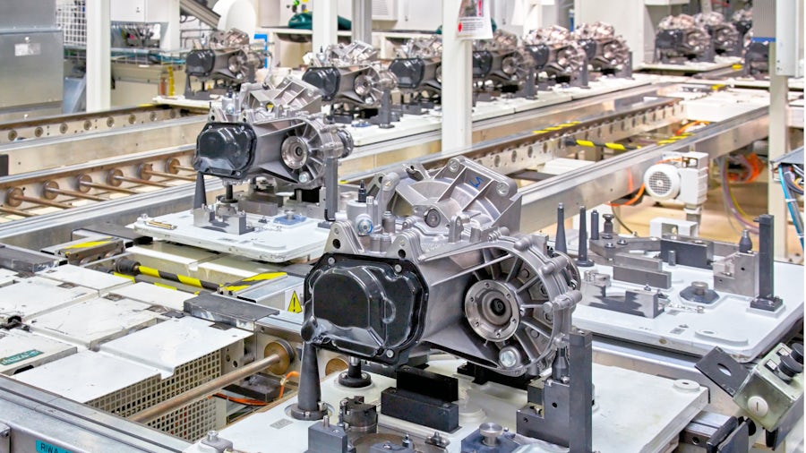 Electric vehicle transmissions coming down a production line.