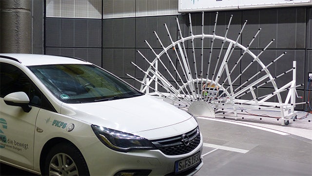 A vehicle in a Simcenter test center for wind tunnel testing.