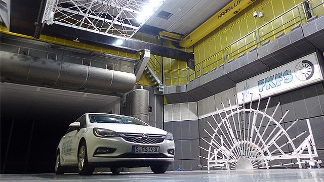A vehicle is parked in a center for wind tunnel testing.