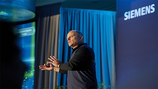 Keynote speaker Mike Ellow presents at the Siemens User2User conference.
