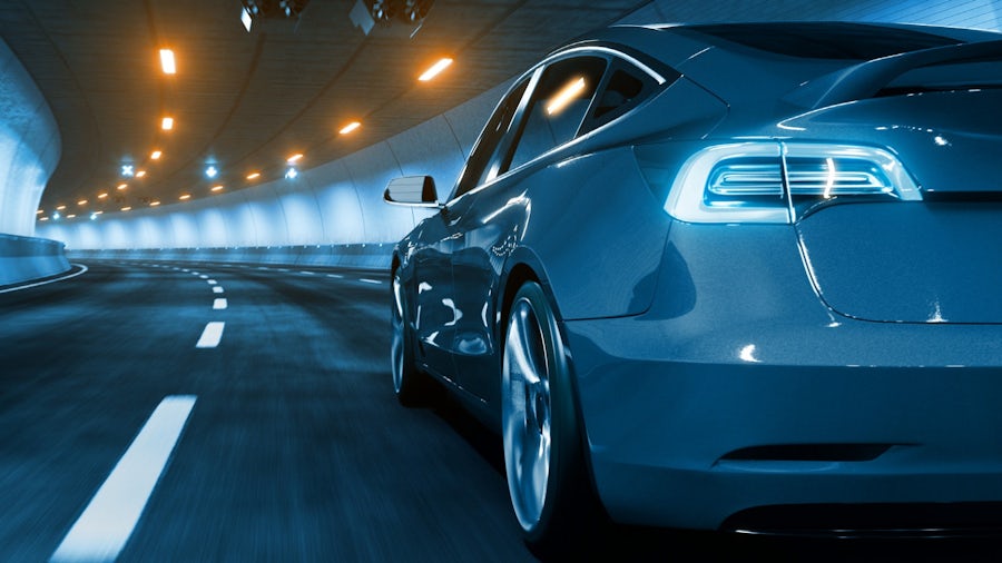 An innovative software defined electrified vehicle built with a complex E/E system driving through a tunnel.