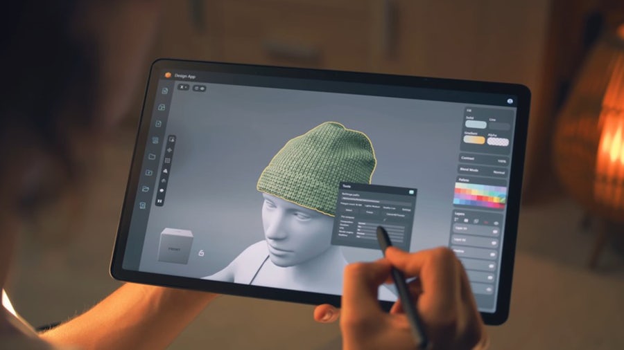 Person holding ipad simulating a fashion hat design 