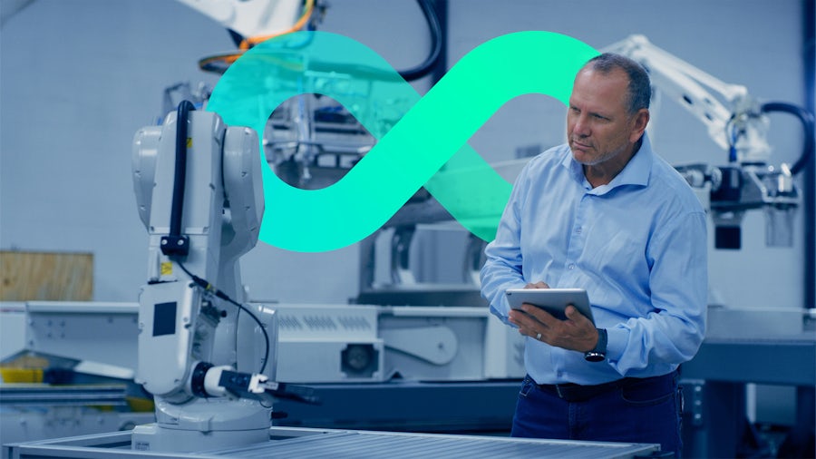 A man holding a tablet while in a medical device manufacturing plant.