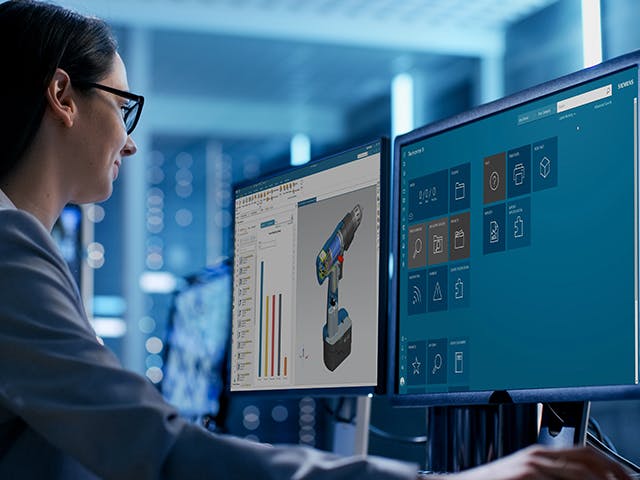 Woman working on computers.