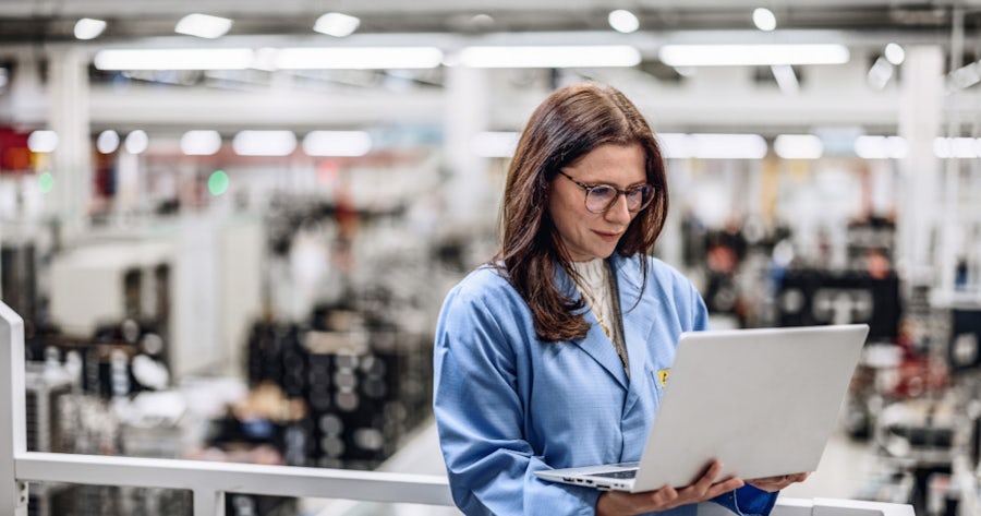 Woman working on a laptop.