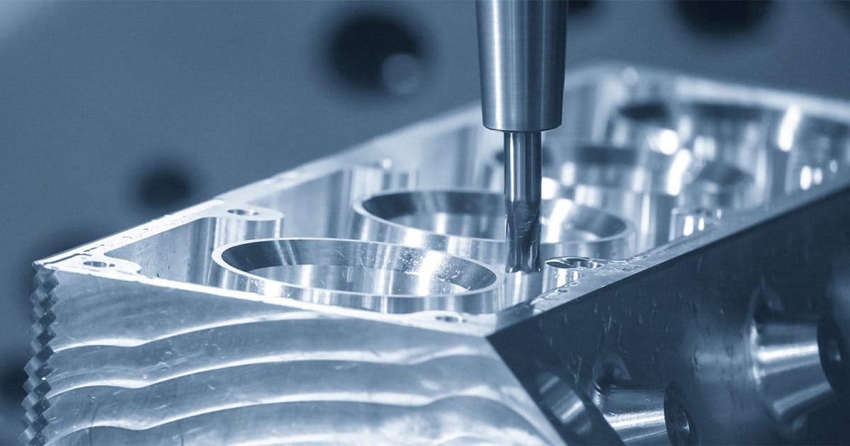 A close-up of a CNC machine as it creates a machinery component using highly automated CAM.