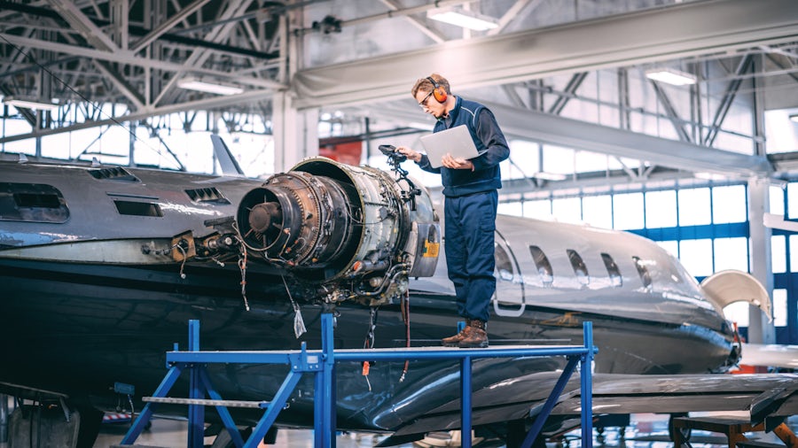 A worker inspects an airplane