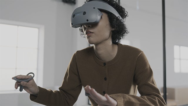 Image of a woman wearing the Sony VR headset.