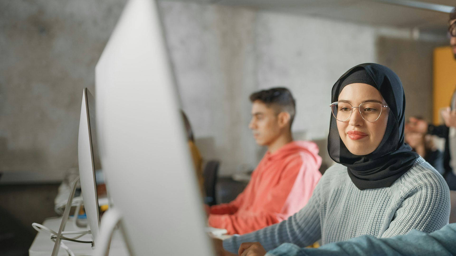 Students having a discussion while working on computers