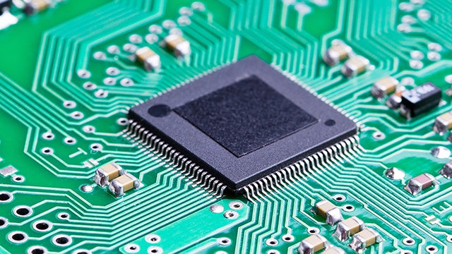 large chip on board with green background