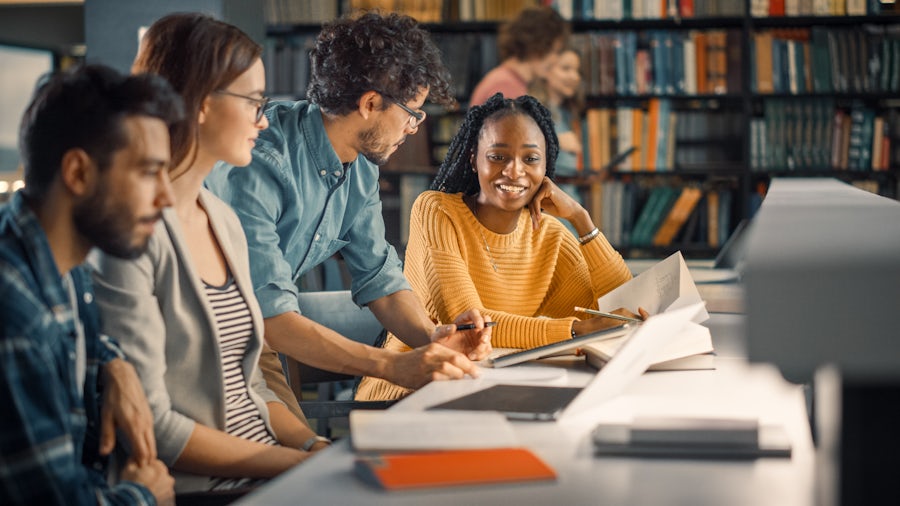 A group of students holding a discussion in a library