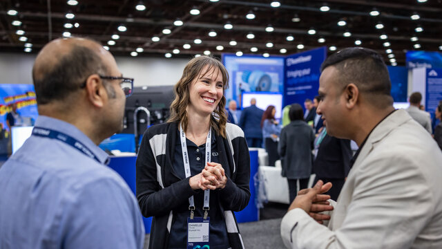 People interacting in the Siemens Solution Center.