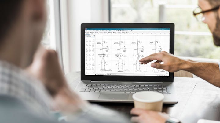 Two people reviewing a electrical diagram on a laptop screen.