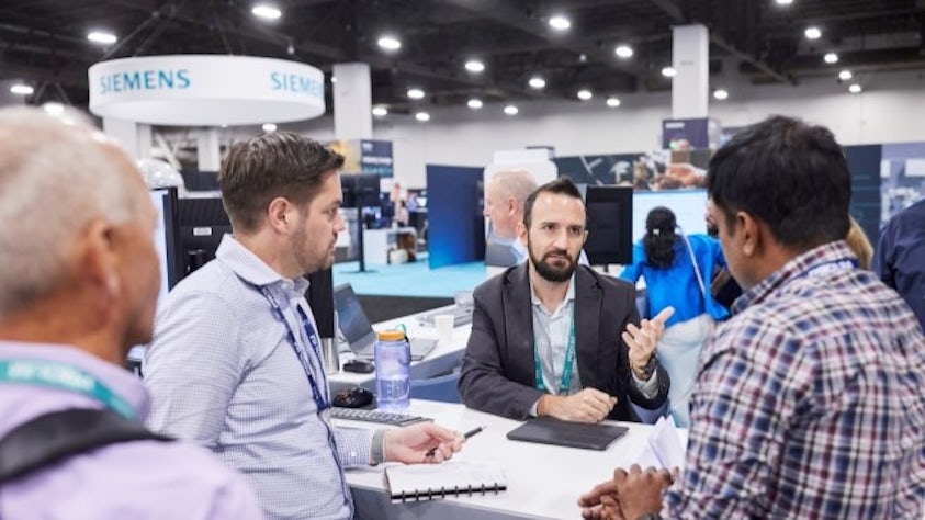 Customers interacting with an expert at a desk in the Solutions Center.