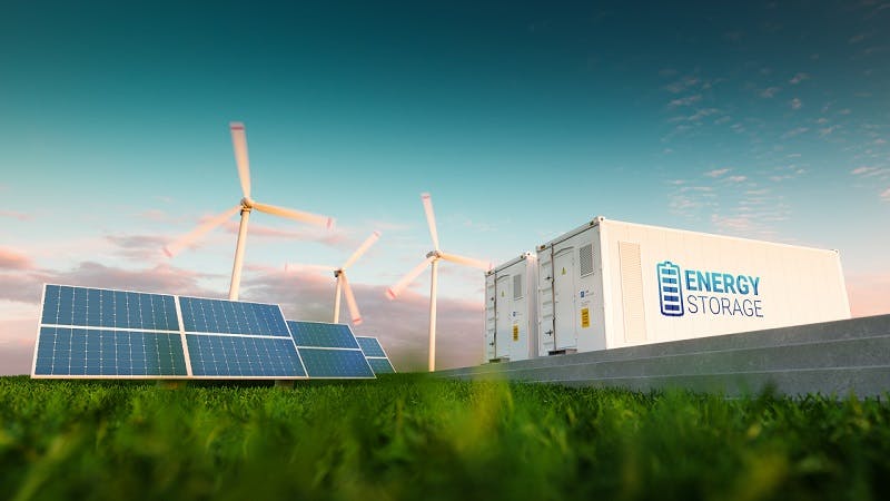 Renewable energy solar panels and wind turbines on grass