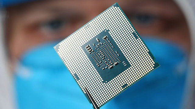 Engineer looking at an IC Packaging chip.