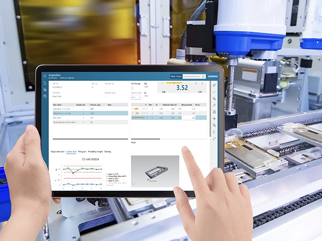 An employee using a tablet to look into the quality control of a product.
