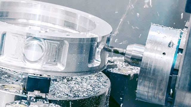 A machine milling a metal part.