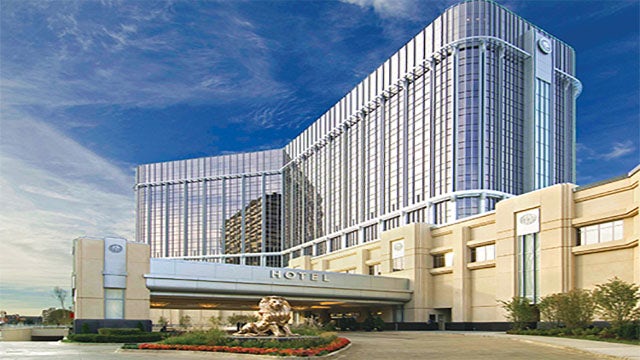 The MGM Grand Detroit Hotel building against a blue sky.