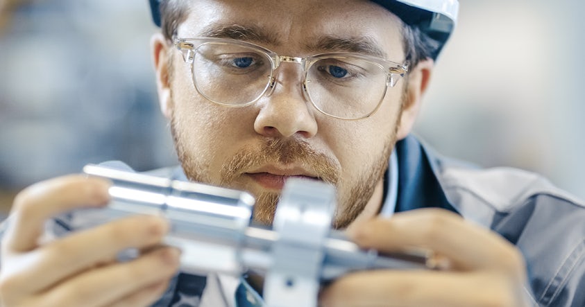 Quality control engineer inspecting a part.