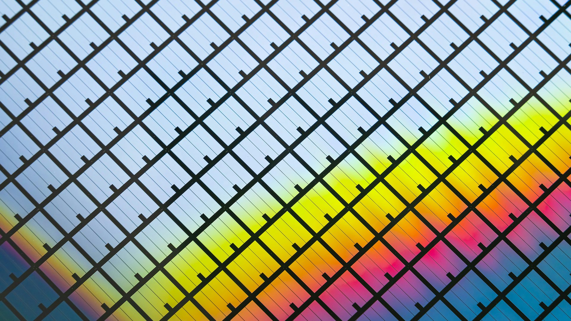 A silicon wafer reflects different colors.