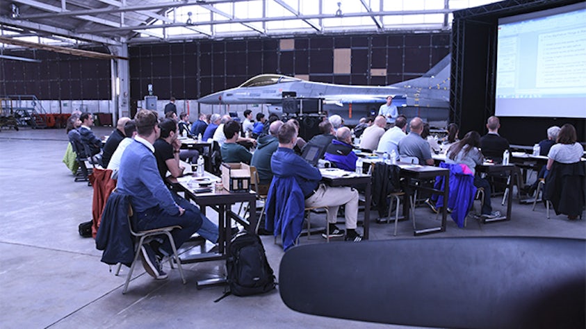 People sitting in a workshop to explore model-based improvement possibilities and the incorporation of model-based engineering.