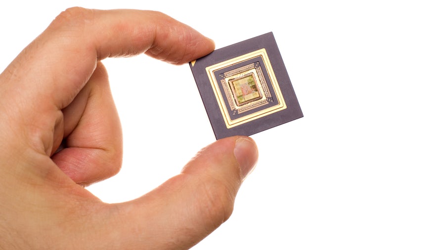 Photo of a hand holding an IC chip