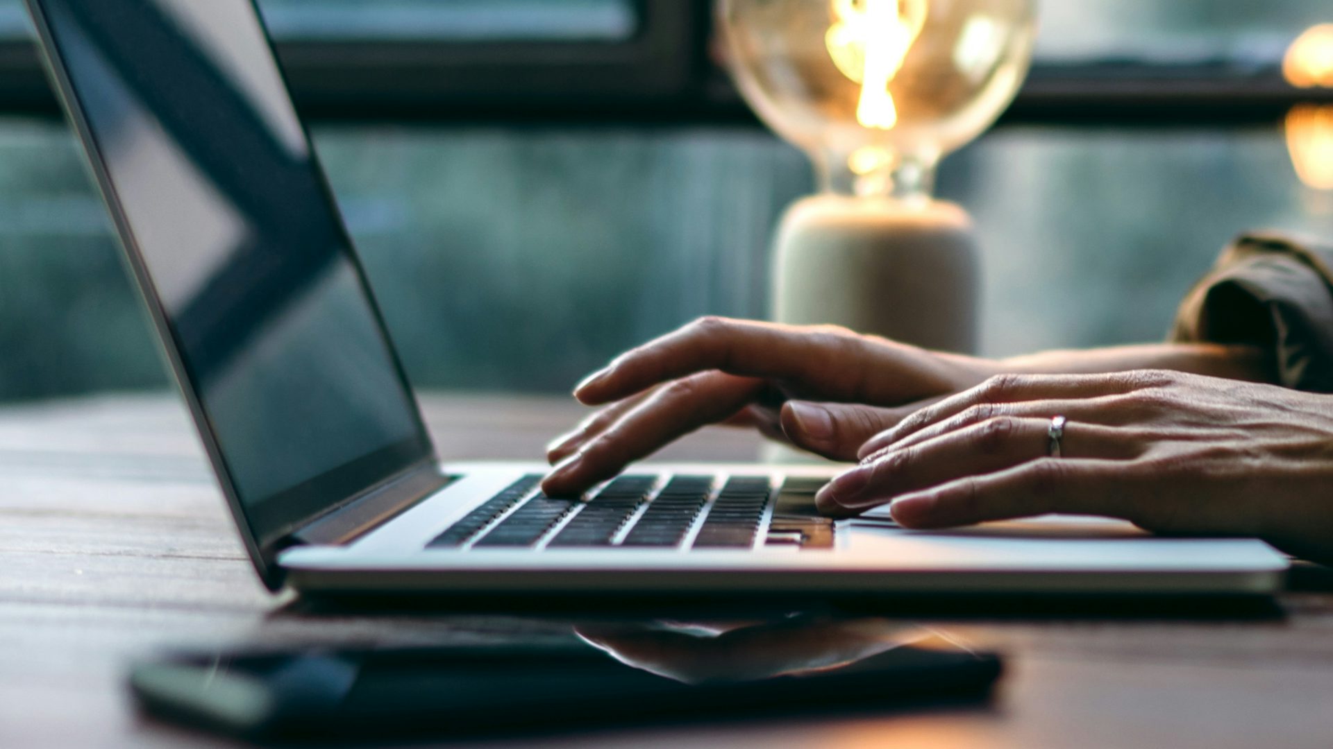 Close-up of hands typing on a keyboard.