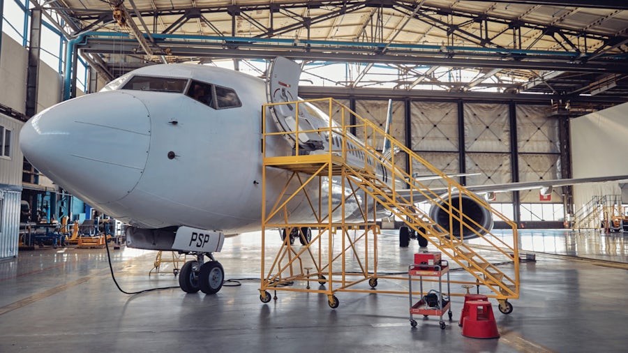 Commercial aircraft in a hangar being serviced. 